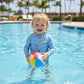 A two-piece kids' swimwear set with a long-sleeved top and swim pants featuring marine fishes